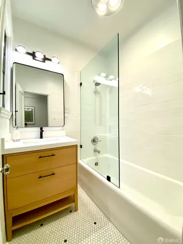 a living room with furniture and floor to ceiling window