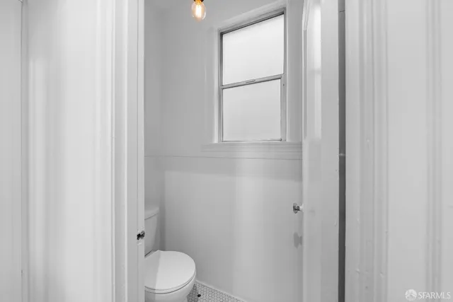 a kitchen with stainless steel appliances kitchen island granite countertop a dining table chairs and a refrigerator