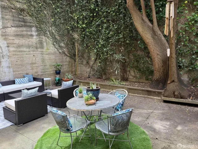 a view of a patio with couches chairs and a fire pit