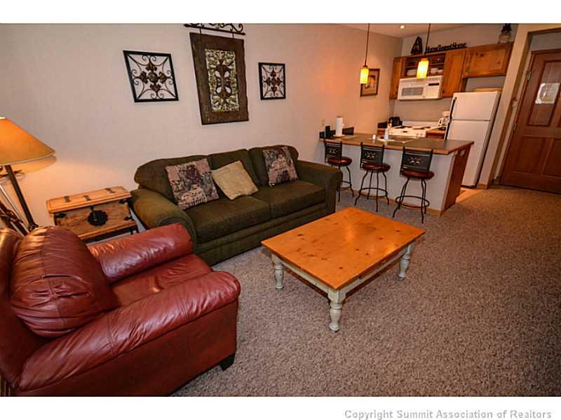 195 River Run Road, Unit 8042 Keystone, CO 80435 - Photo 2 of 25 a living room with furniture and a dining table
