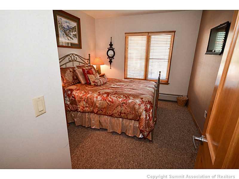 195 River Run Road, Unit 8042 Keystone, CO 80435 - Photo 15 of 25 a bedroom with a bed and a window