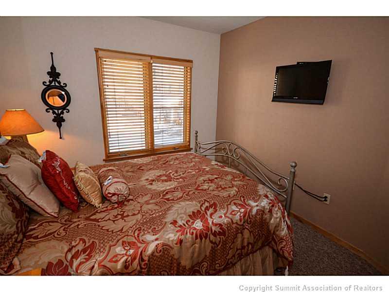 195 River Run Road, Unit 8042 Keystone, CO 80435 - Photo 16 of 25 a bed room with a bed a television and a window
