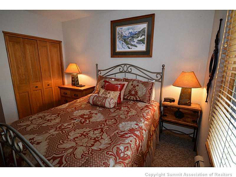 195 River Run Road, Unit 8042 Keystone, CO 80435 - Photo 17 of 25 a bedroom with a bed and a lamp on dresser