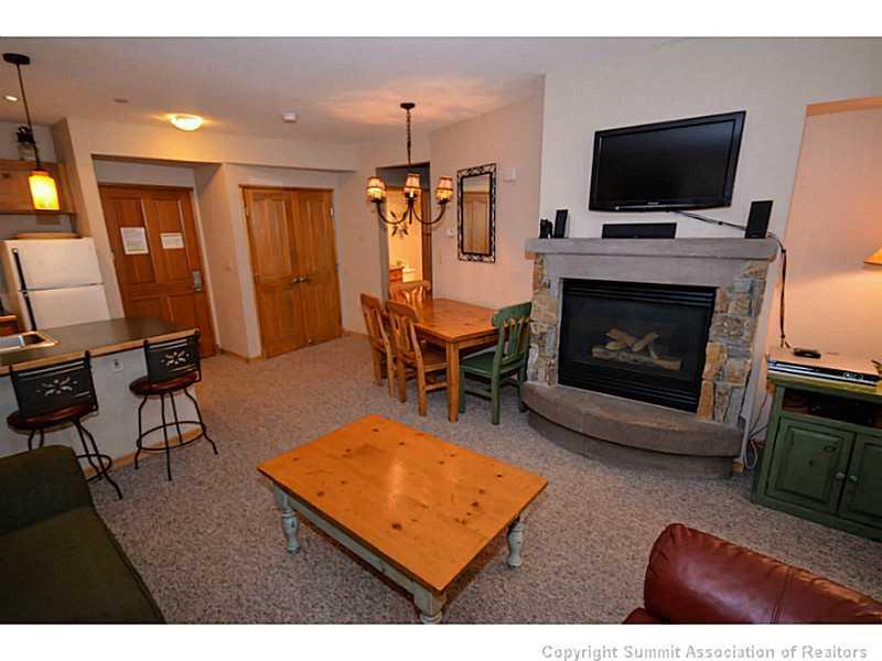 195 River Run Road, Unit 8042 Keystone, CO 80435 - Photo 3 of 25 a living room with furniture a flat screen tv and a fireplace
