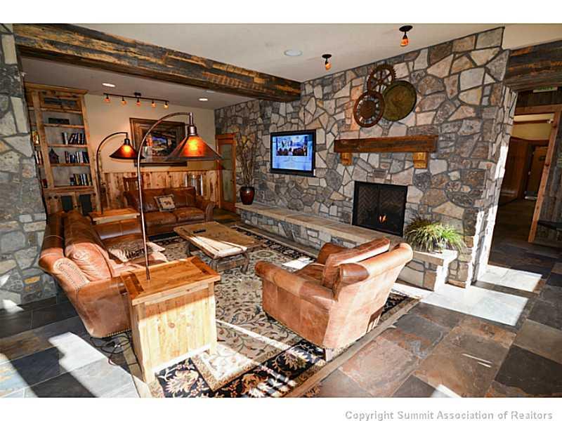 195 River Run Road, Unit 8042 Keystone, CO 80435 - Photo 23 of 25 a living room with furniture a flat screen tv and a fireplace