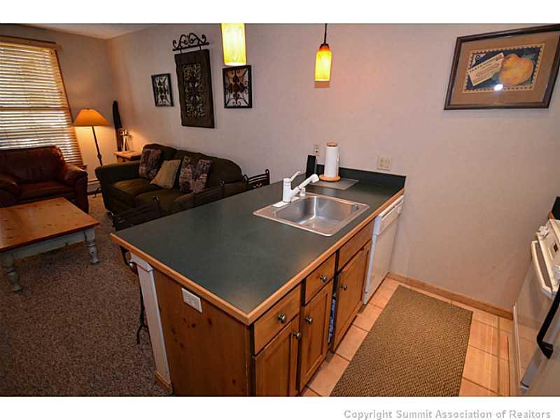 195 River Run Road, Unit 8042 Keystone, CO 80435 - Photo 9 of 25 a kitchen that has a sink and a stove in it