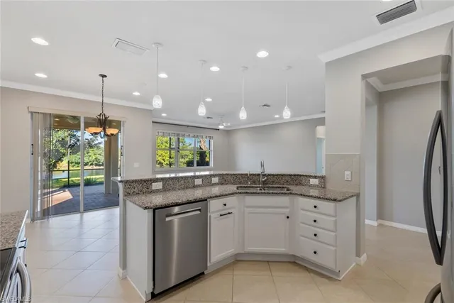 a kitchen with granite countertop a sink stove and cabinets