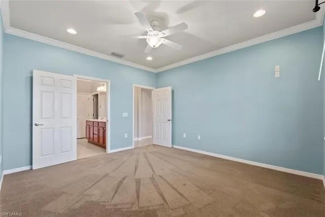 wooden floor in an empty room with a ceiling fan