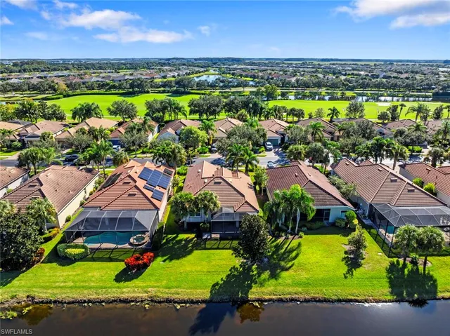 an aerial view of a houses with a lake view