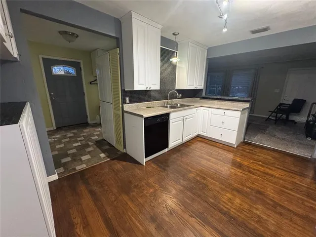a view of a kitchen with a sink and a refrigerator
