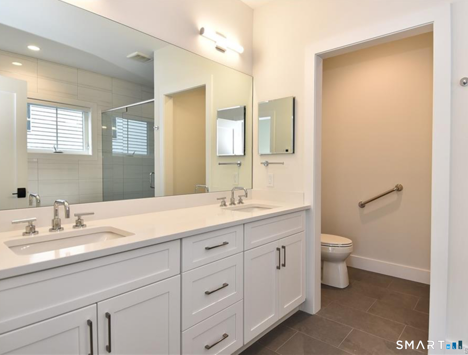 40 Fullin Road, Unit 19 Norwalk, CT 06851 - Photo 11 of 24 a bathroom with a double vanity sink toilet and a mirror