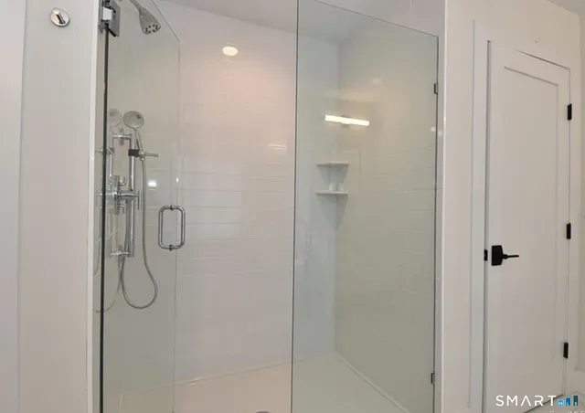 a bathroom with a glass shower door