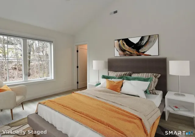 a bedroom with a bed and chair