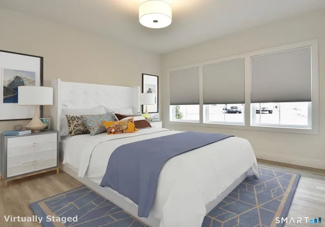 a bedroom with a bed and window