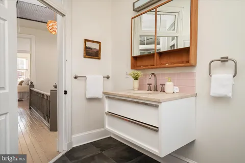 a bathroom with a sink a mirror and shower
