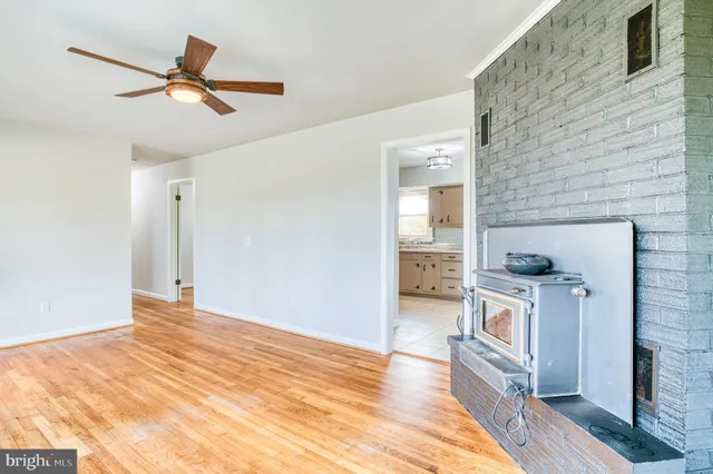 a workspace with wooden floor and a ceiling fan