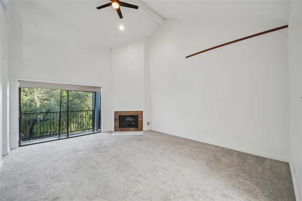 an empty room with floor to ceiling window