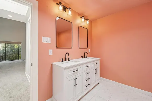 a bathroom with a double vanity sink mirror and