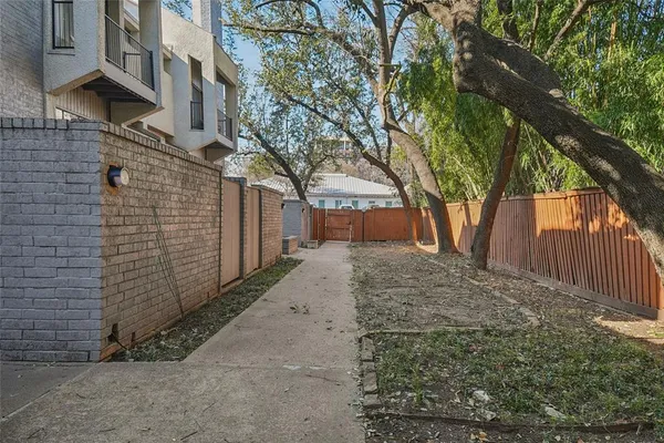 a view of a yard filled with lots of trees