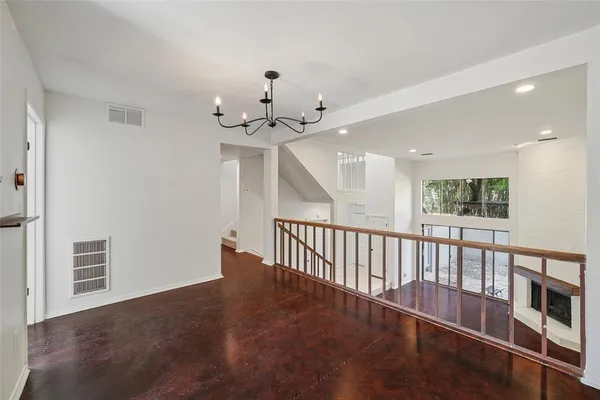 a view of staircase with wooden floor and fan
