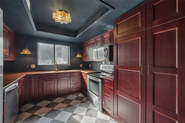 a kitchen with stainless steel appliances granite countertop a refrigerator and a sink