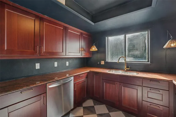 a kitchen with stainless steel appliances granite countertop a sink stove and cabinets