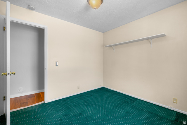 2088 Falcon Way Sandy, UT 84093 - Photo 19 of 46 Room with green patterned carpeting, light beige walls, and white baseboards