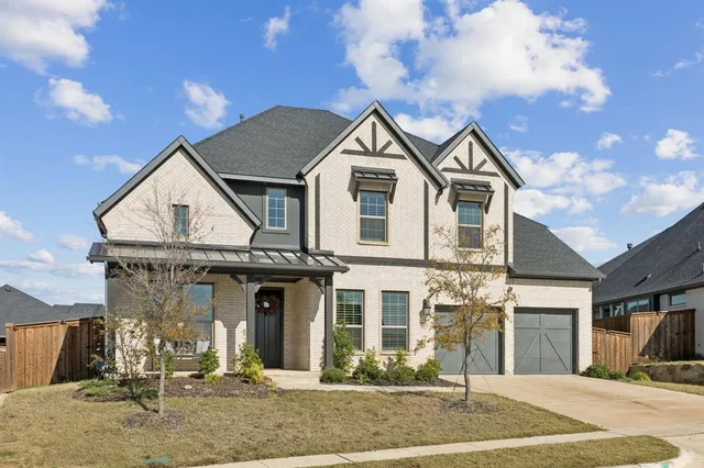 a view of a big house with a yard and plants