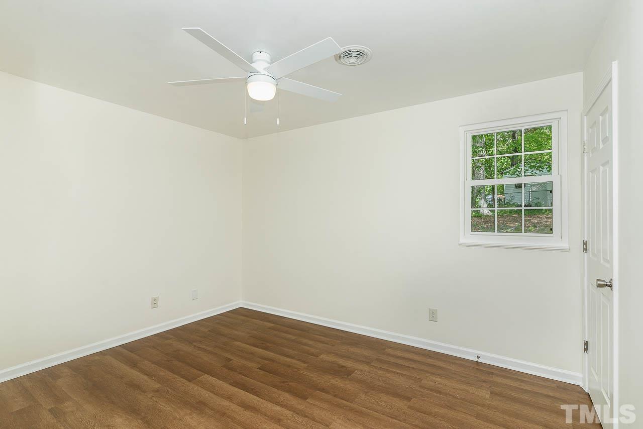 1905 Crawford Road Raleigh, NC 27610 - Photo 13 of 16 an empty room with wooden floor and windows