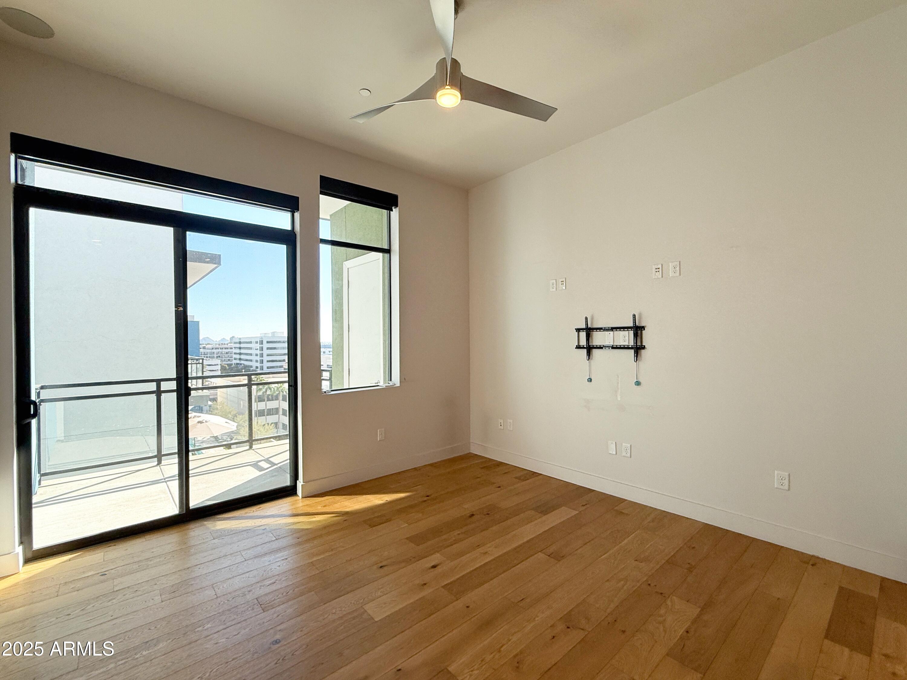 3131 North Central Avenue, Unit 7004 Phoenix, AZ 85012 - Photo 2 of 26 wooden floor in an empty room with a window