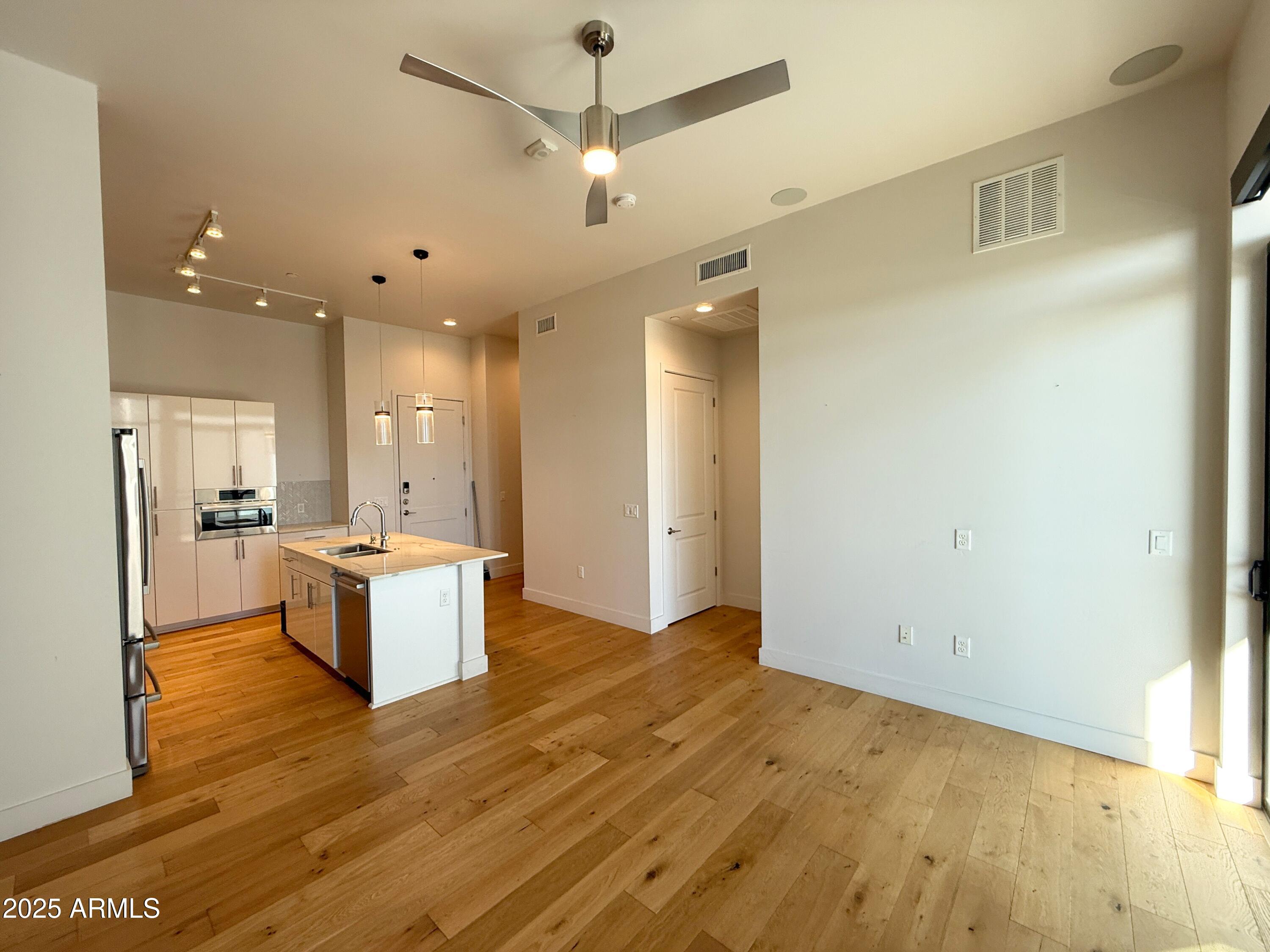 3131 North Central Avenue, Unit 7004 Phoenix, AZ 85012 - Photo 4 of 26 a view of a kitchen and a refrigerator chandelier