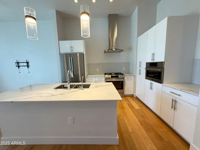a kitchen with kitchen island sink stove and refrigerator