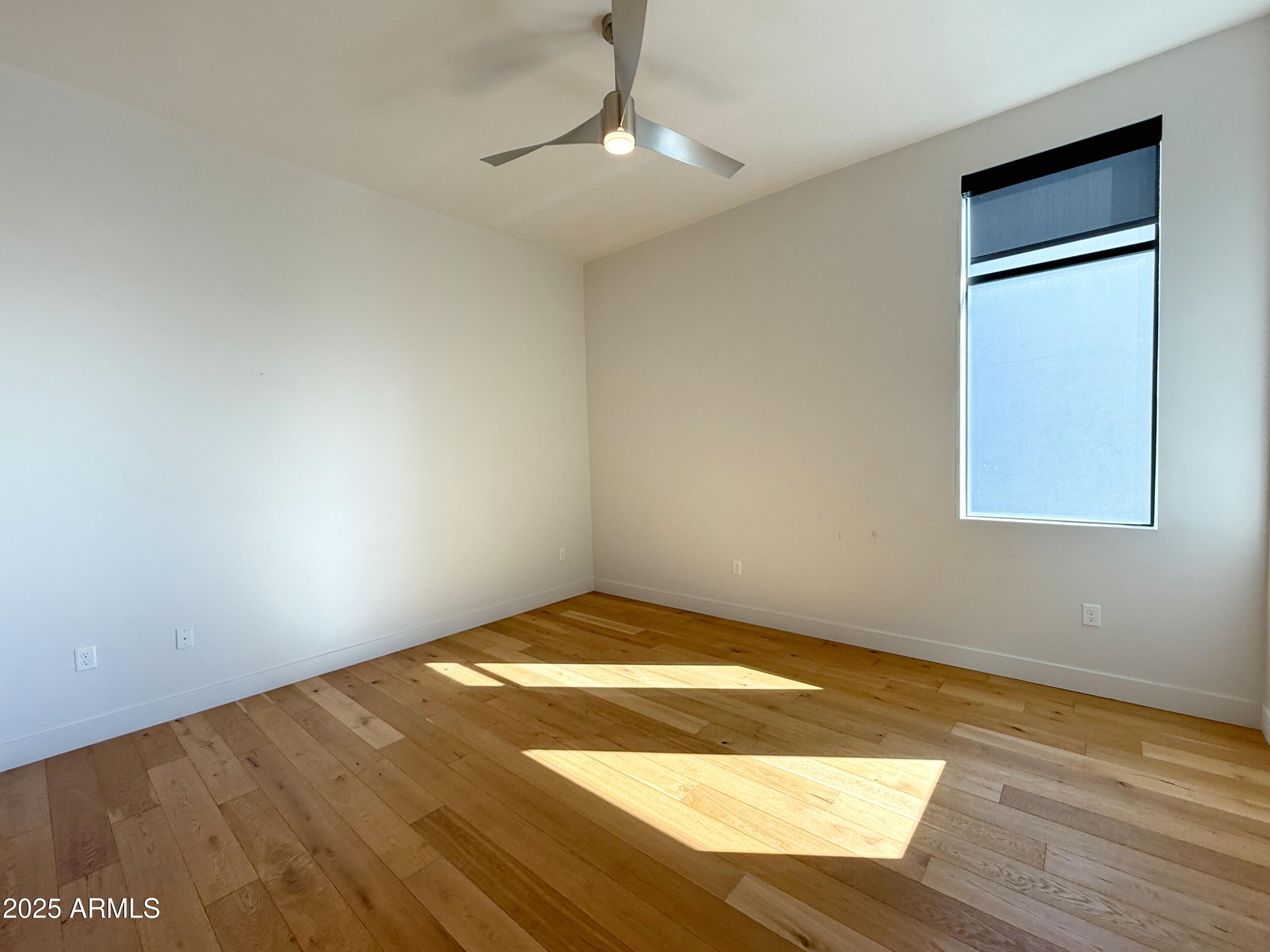 3131 North Central Avenue, Unit 7004 Phoenix, AZ 85012 - Photo 9 of 26 a view of empty room with wooden floor