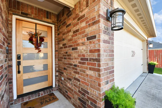a view of a balcony with wooden floor and door