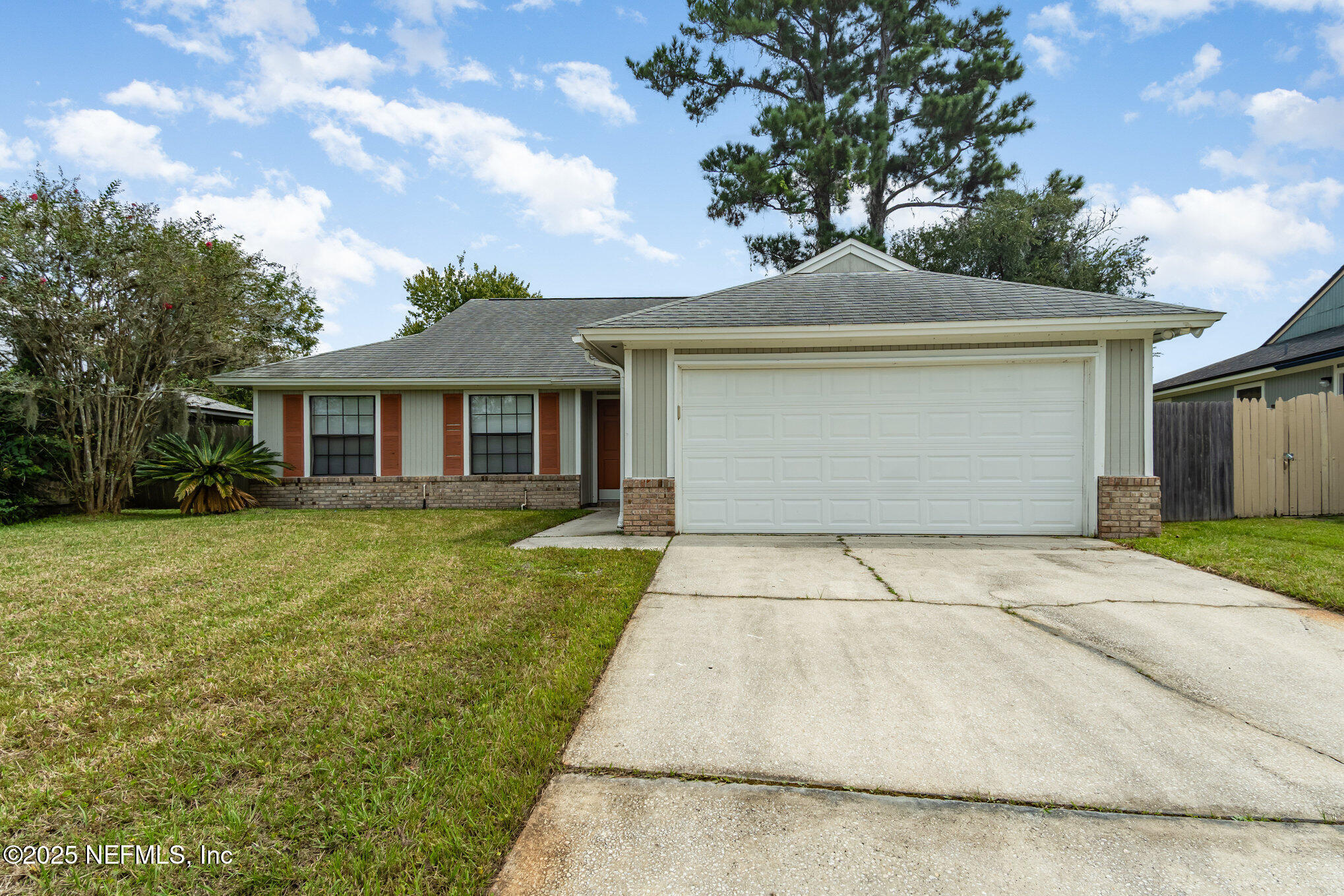 7945 Amandas Crossing Drive East Jacksonville, FL 32244 - Photo 1 of 15 a front view of a house with a yard and garage