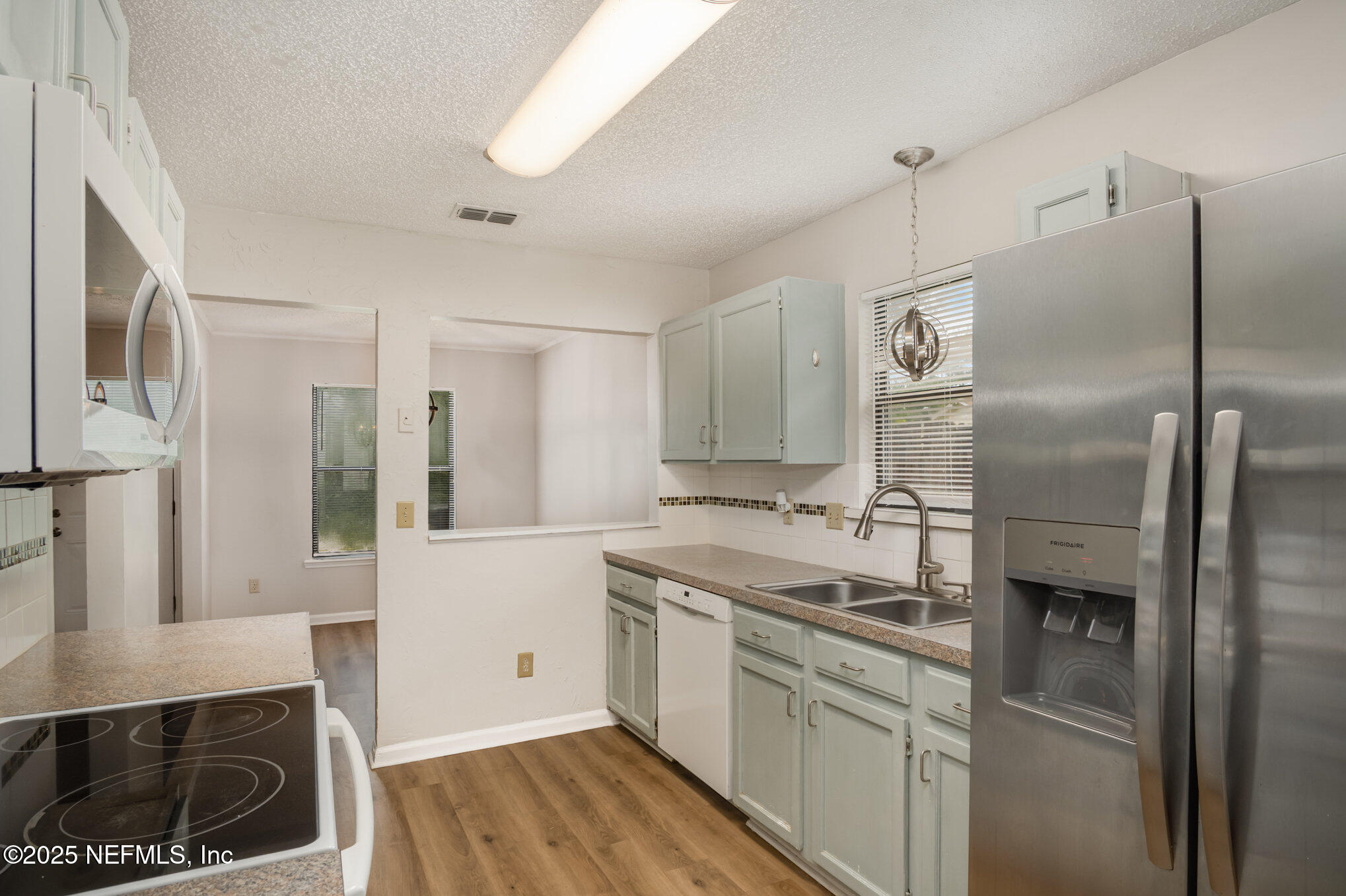 7945 Amandas Crossing Drive East Jacksonville, FL 32244 - Photo 11 of 15 a kitchen with a sink stove and refrigerator