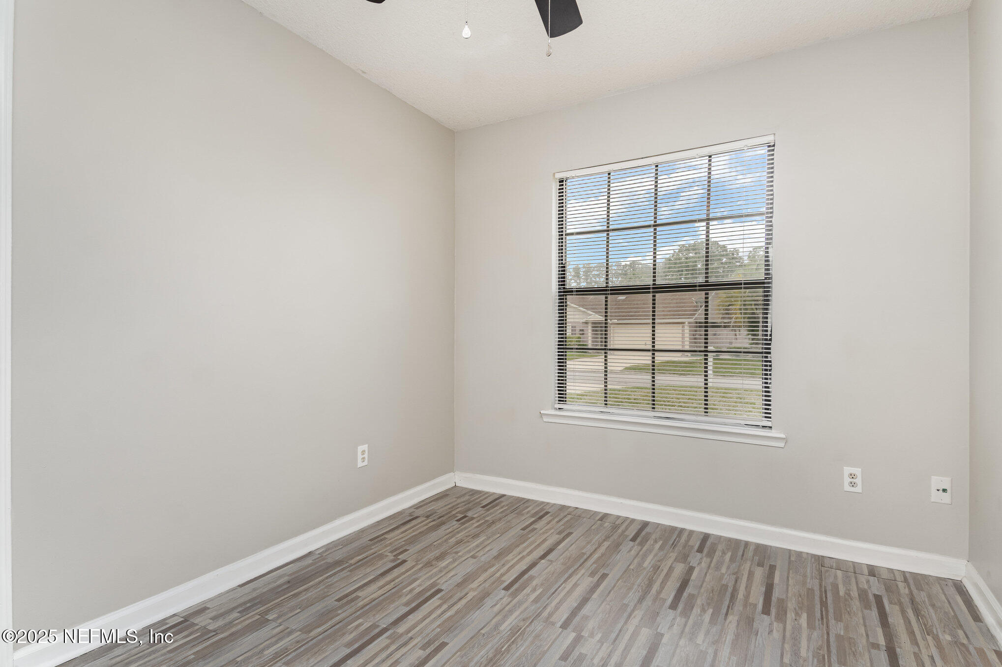 7945 Amandas Crossing Drive East Jacksonville, FL 32244 - Photo 12 of 15 an empty room with wooden floor and windows