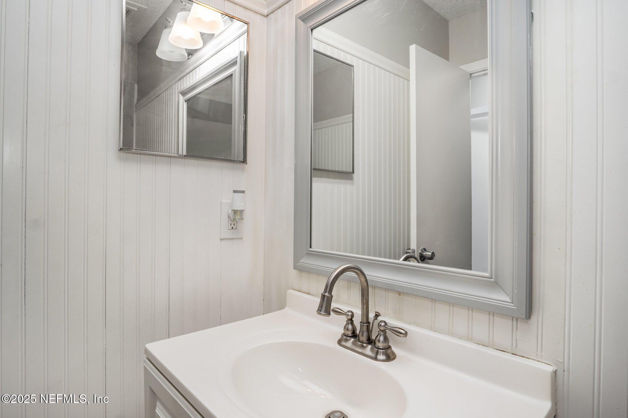 7945 Amandas Crossing Drive East Jacksonville, FL 32244 - Photo 13 of 15 a bathroom with a sink and a mirror