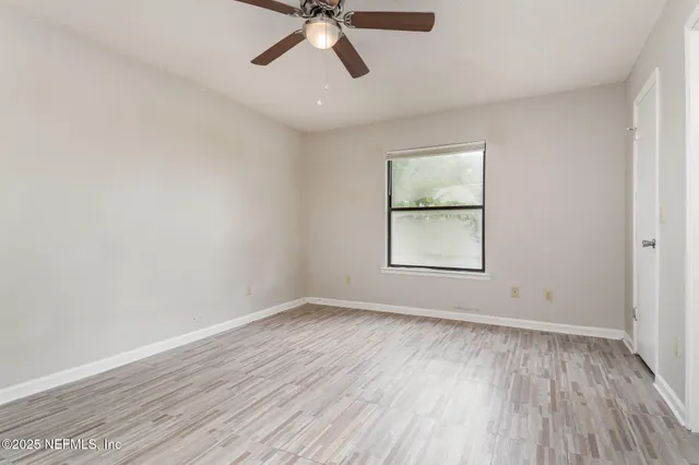 wooden floor in an empty room with a window