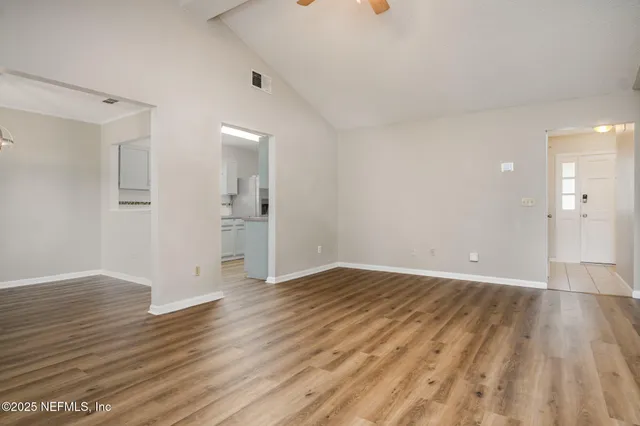 wooden floor in an empty room with a window