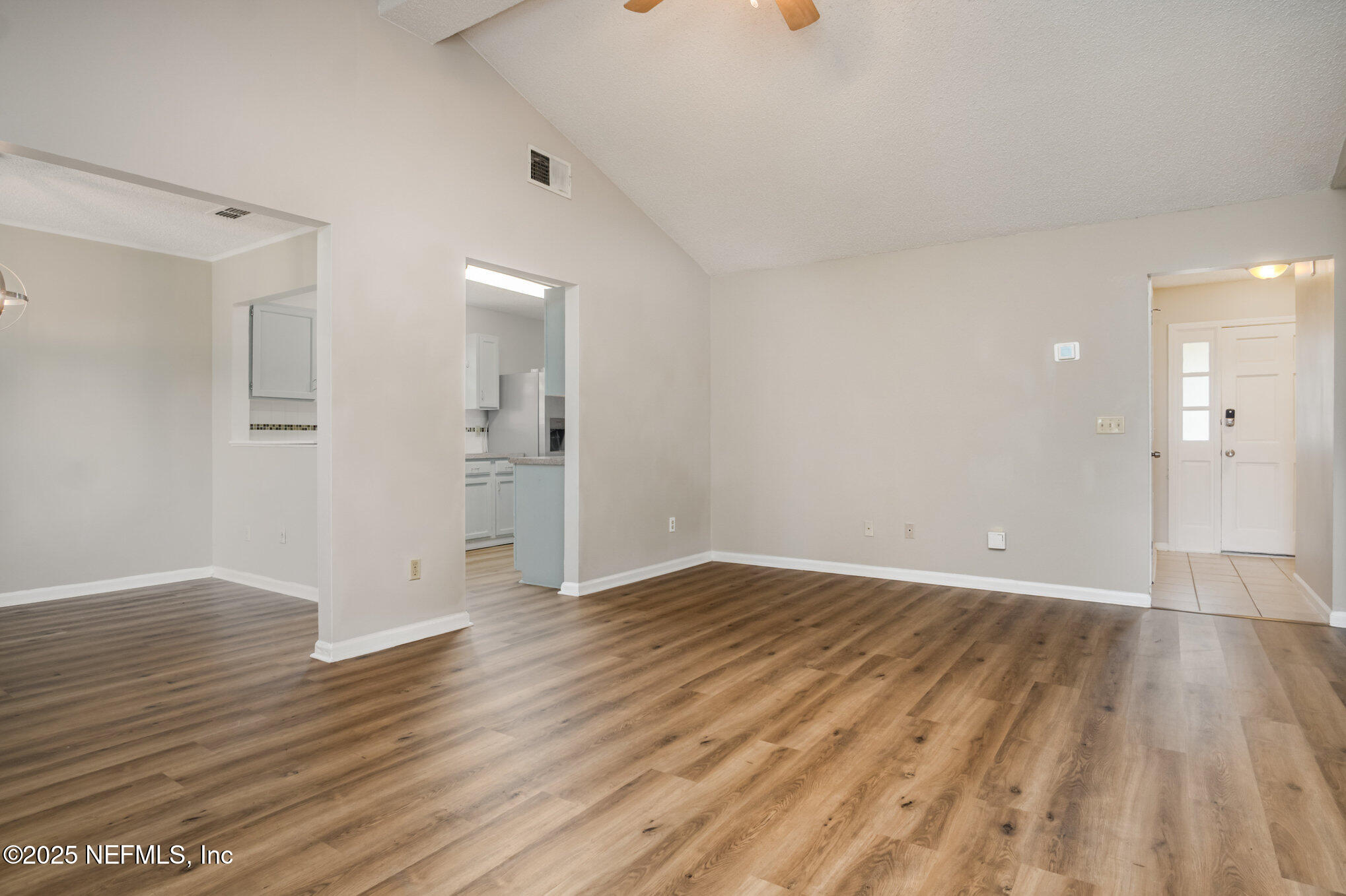7945 Amandas Crossing Drive East Jacksonville, FL 32244 - Photo 9 of 15 wooden floor in an empty room with a window
