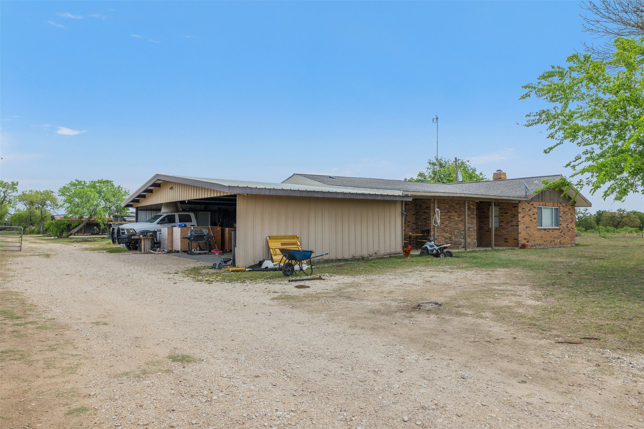 9765 State Park Road Lockhart, TX 78644 - Photo 14 of 40 a view of a house with a patio and a yard