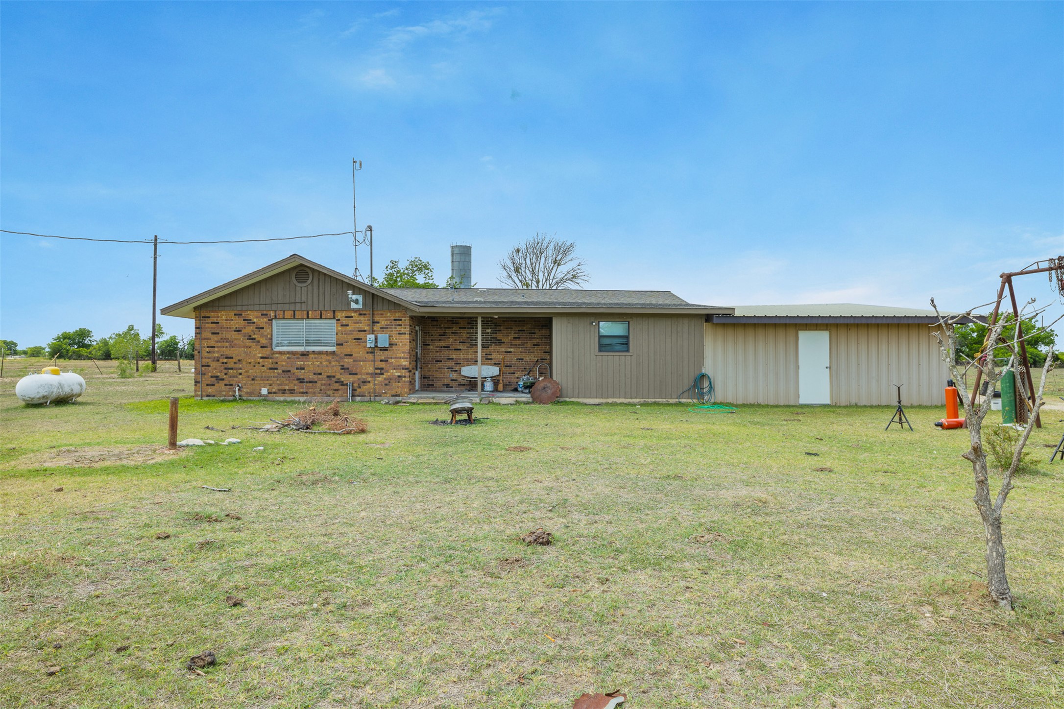 9765 State Park Road Lockhart, TX 78644 - Photo 16 of 40 a front view of the house with a garden