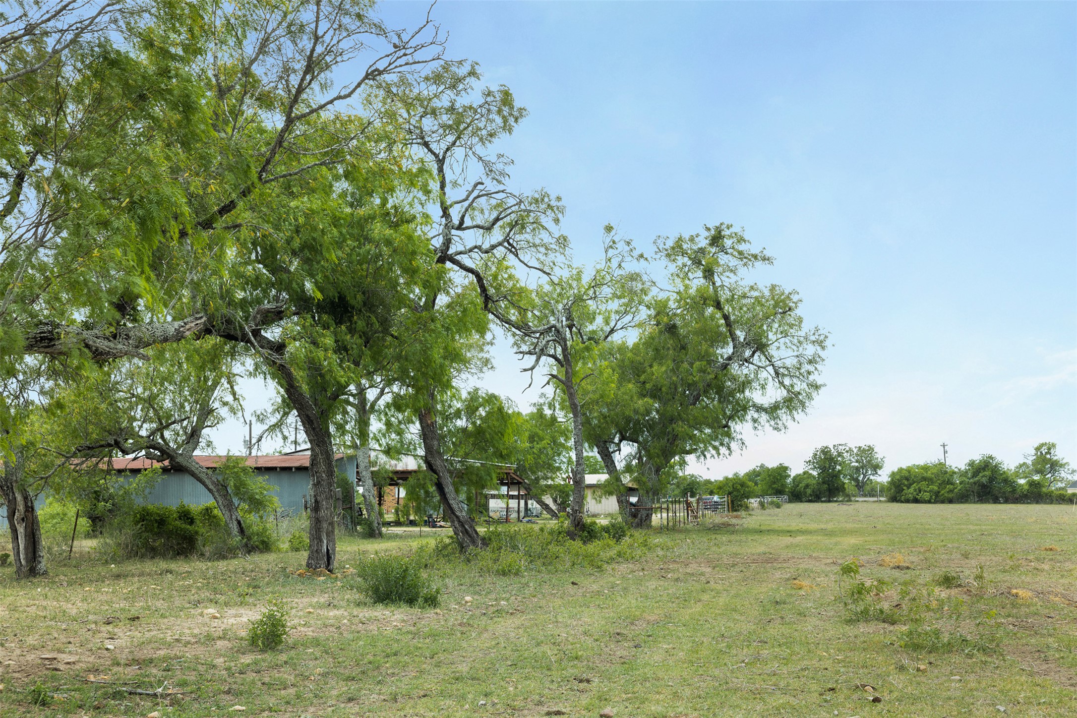 9765 State Park Road Lockhart, TX 78644 - Photo 32 of 40 a backyard of a house with lots of green space