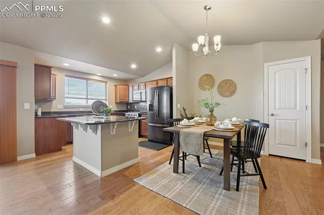 a kitchen with a table and chairs in it