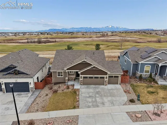 an aerial view of a house with a ocean view
