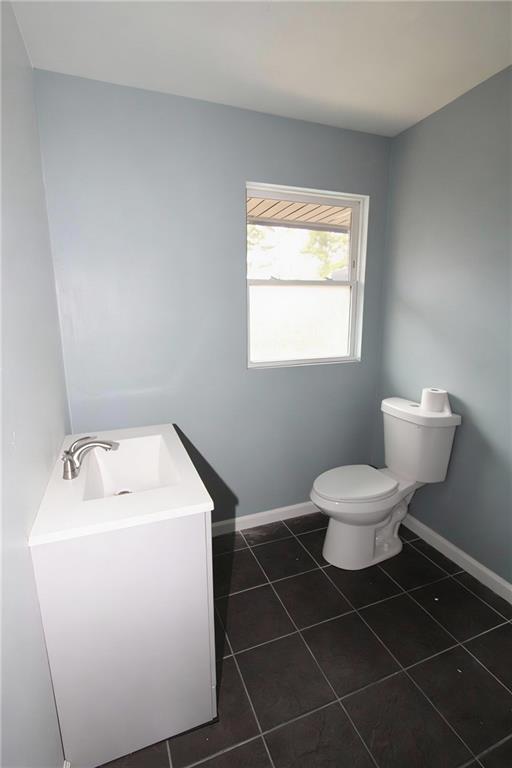 706 Collins Hill Road Lawrenceville, GA 30046 - Photo 17 of 33 a bathroom with a toilet sink and a mirror