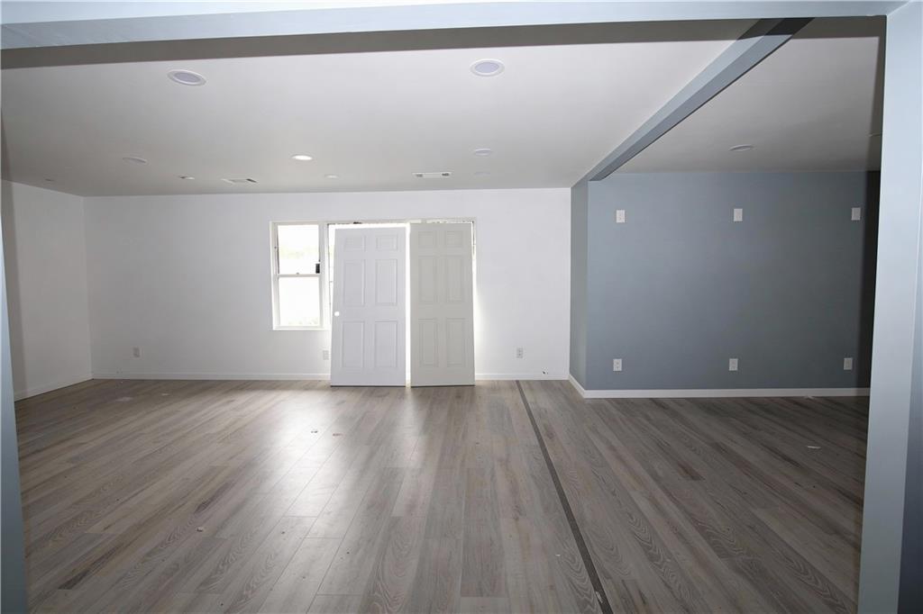 706 Collins Hill Road Lawrenceville, GA 30046 - Photo 20 of 33 an empty room with wooden floor and windows