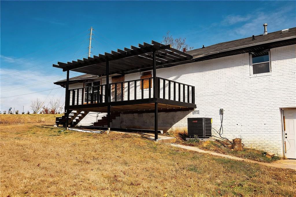 706 Collins Hill Road Lawrenceville, GA 30046 - Photo 22 of 33 a view of a house with wooden floor roof and furniture