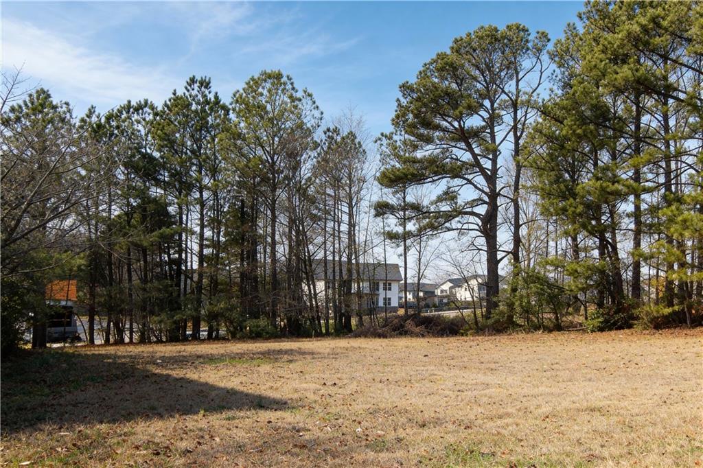 706 Collins Hill Road Lawrenceville, GA 30046 - Photo 26 of 33 a street view with large trees